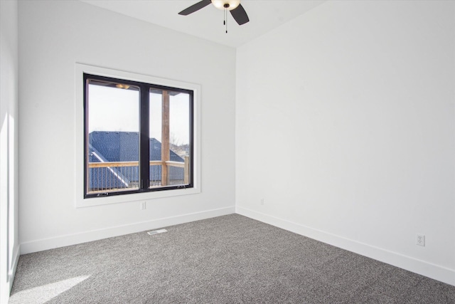 carpeted spare room with ceiling fan