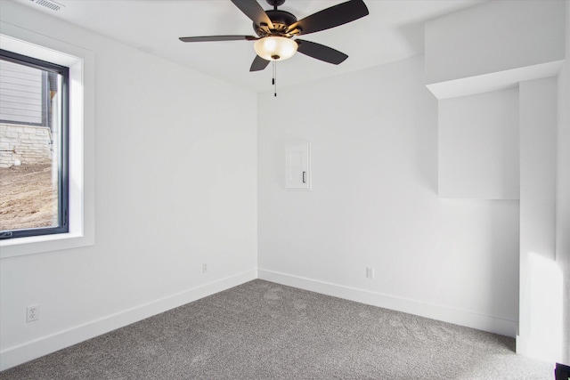 empty room with ceiling fan and carpet floors