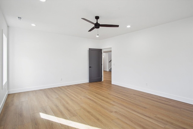 empty room featuring ceiling fan and light wood-type flooring