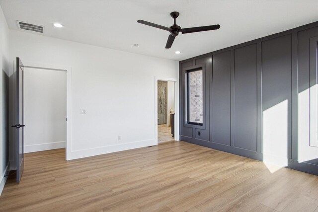 unfurnished bedroom with ceiling fan and light hardwood / wood-style floors