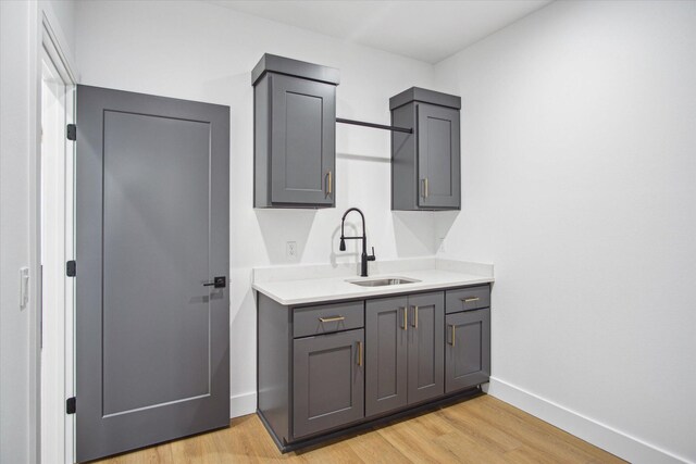 kitchen featuring sink, gray cabinets, and light hardwood / wood-style floors