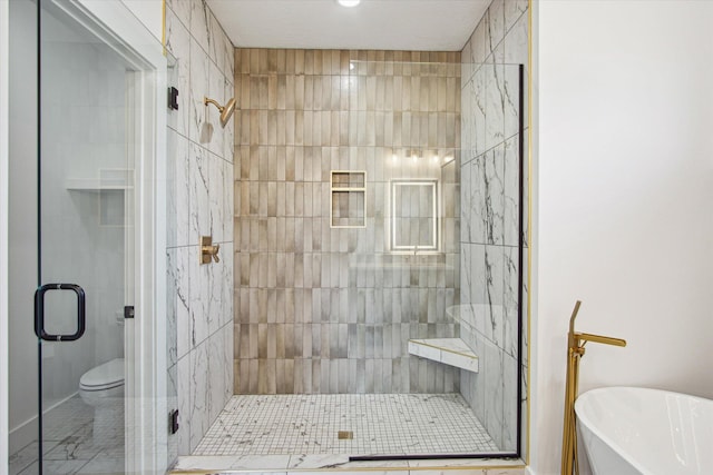 bathroom featuring shower with separate bathtub and toilet