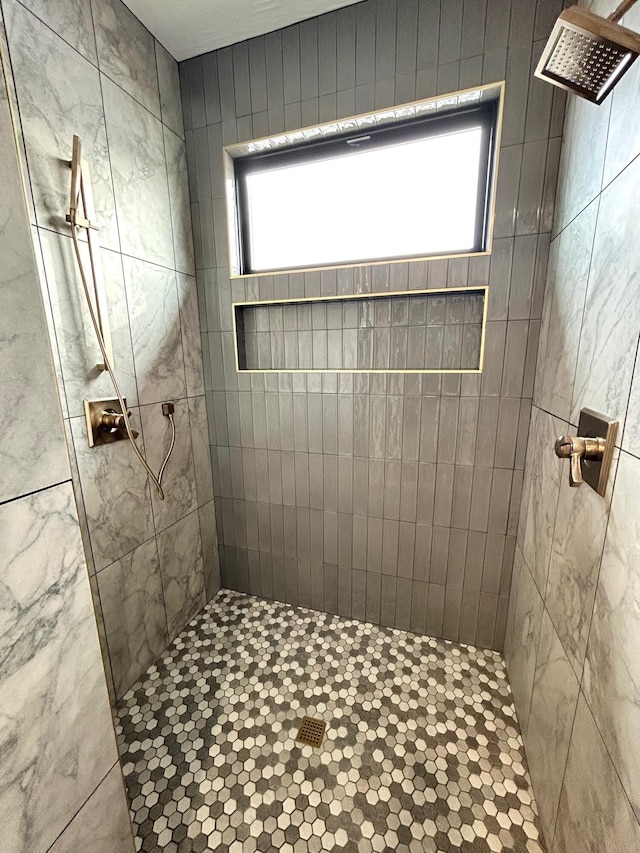 bathroom with tiled shower