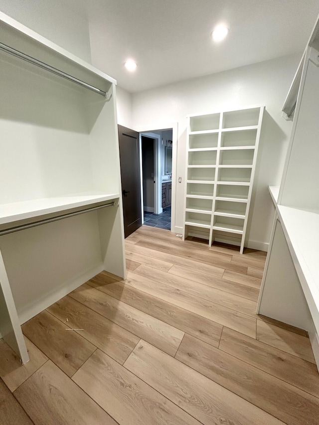 spacious closet with light hardwood / wood-style flooring