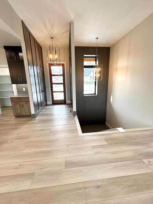 entryway with a chandelier and light hardwood / wood-style floors