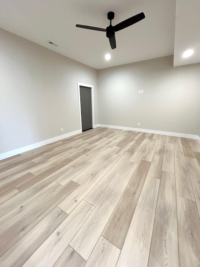 empty room with light wood-type flooring and ceiling fan