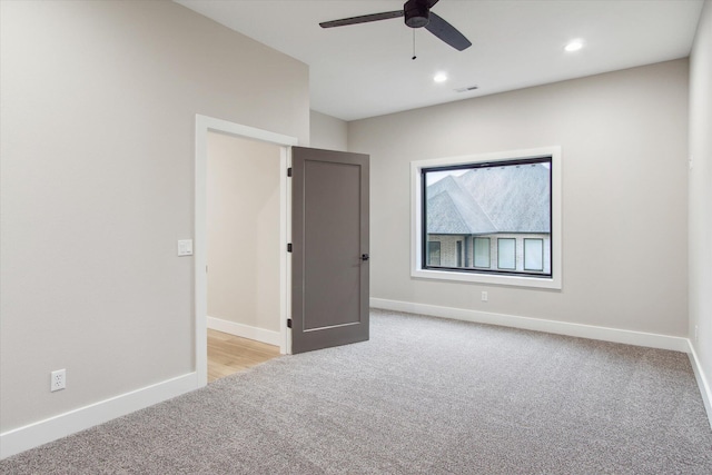 unfurnished room with light carpet, baseboards, recessed lighting, and a ceiling fan