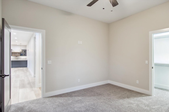unfurnished room featuring baseboards, recessed lighting, a ceiling fan, and light colored carpet