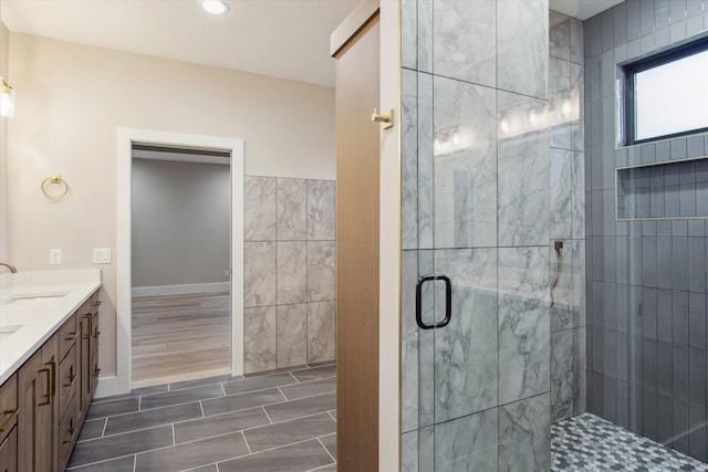 bathroom with a shower stall and vanity
