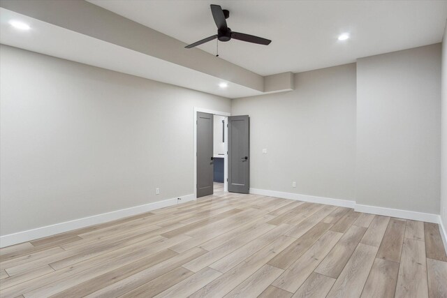spare room with baseboards, light wood-style floors, recessed lighting, and a ceiling fan