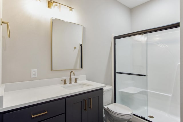 bathroom featuring vanity, toilet, and a shower stall
