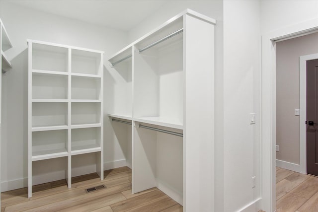 spacious closet with light wood-style flooring and visible vents