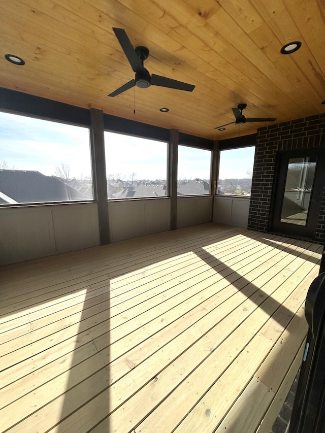 wooden terrace featuring a ceiling fan