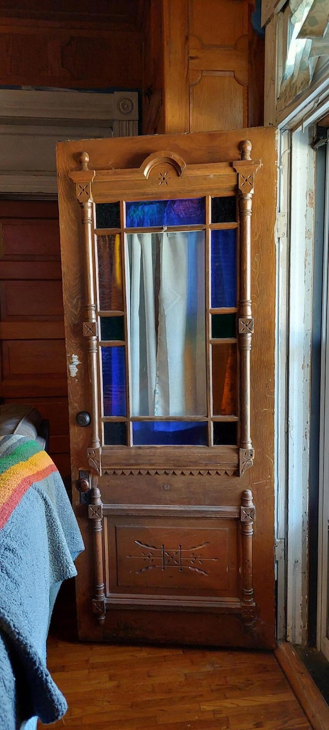 details featuring hardwood / wood-style flooring and wooden walls