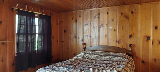 bedroom featuring wooden walls