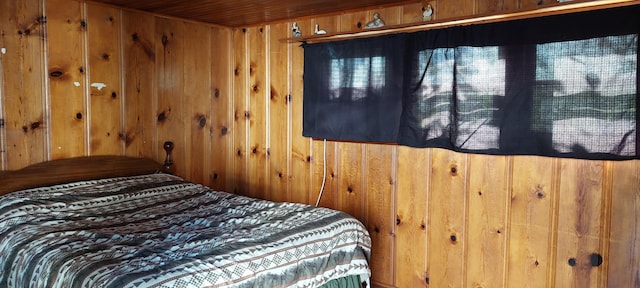 bedroom with wooden ceiling and wooden walls