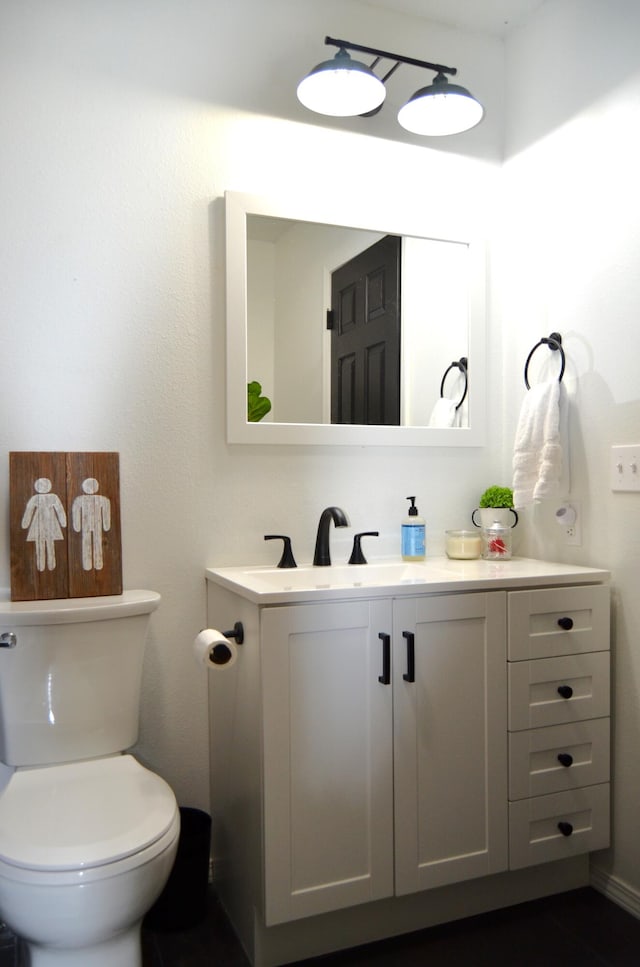 bathroom featuring toilet and vanity