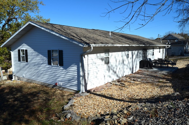 view of side of property featuring a patio area