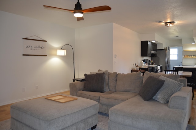 living room featuring hardwood / wood-style floors and ceiling fan