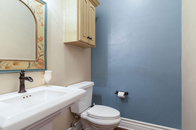 bathroom featuring sink and toilet