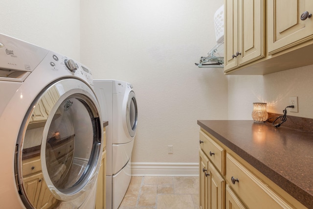 washroom with washing machine and dryer and cabinets