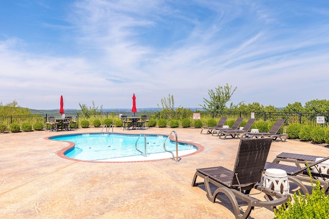 view of swimming pool featuring a patio