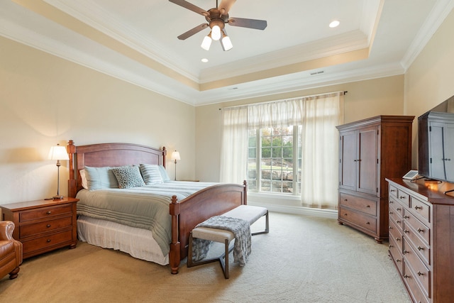 bedroom featuring crown molding, light colored carpet, ceiling fan, and a raised ceiling