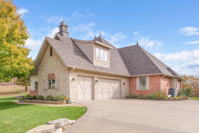 view of front of home featuring a garage, central air condition unit, and a front lawn