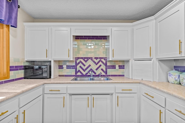 kitchen with decorative backsplash, sink, a textured ceiling, and white cabinets