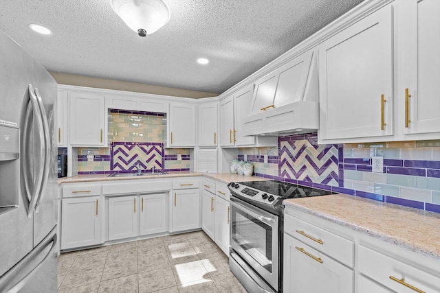 kitchen with tasteful backsplash, white cabinetry, stainless steel appliances, and a textured ceiling