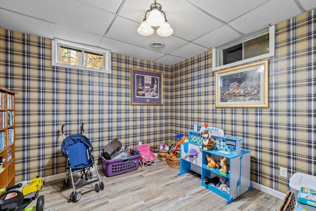 game room featuring hardwood / wood-style flooring and a drop ceiling