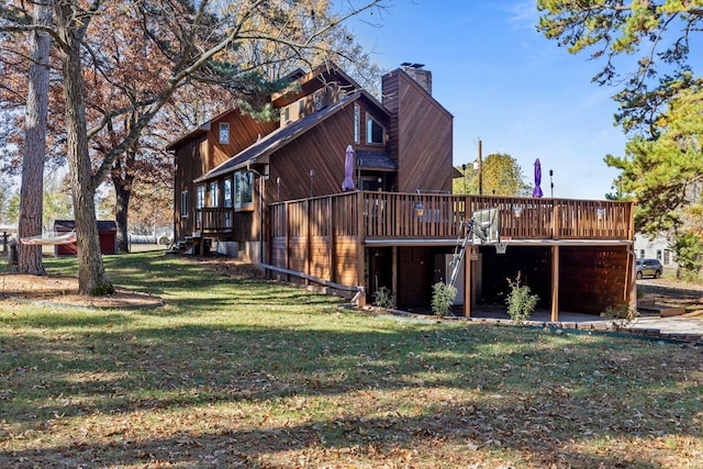 rear view of property featuring a deck and a yard