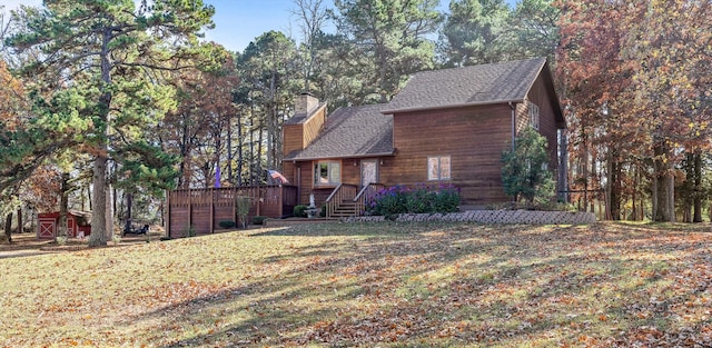 view of front of home featuring a wooden deck and a front lawn