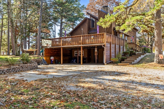 back of house with a wooden deck