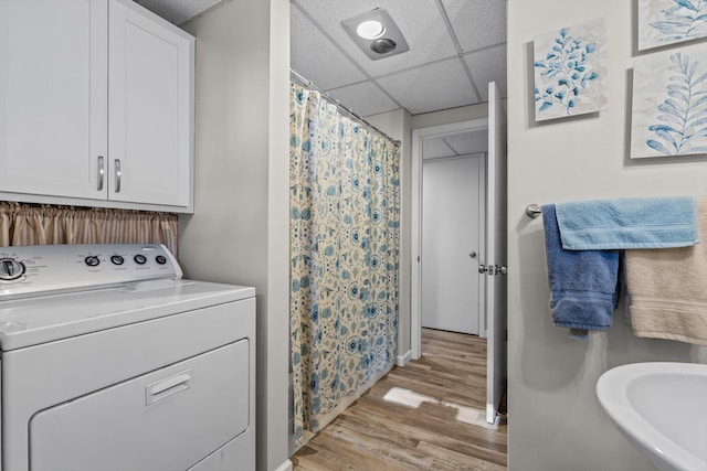 laundry area featuring sink, light hardwood / wood-style flooring, and washer / clothes dryer