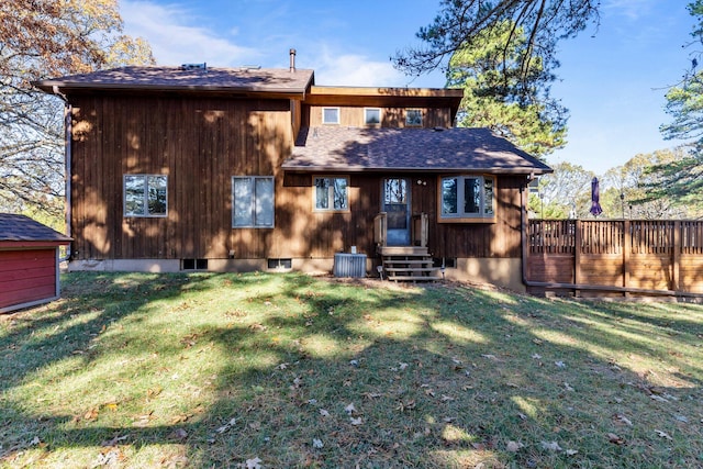 rear view of house featuring a lawn