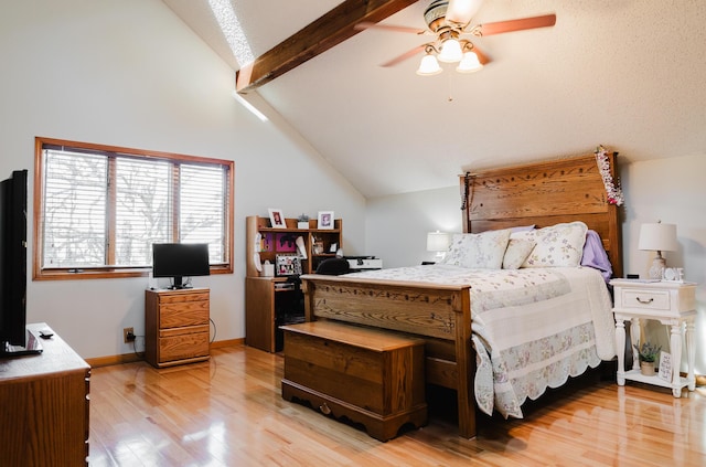 bedroom featuring ceiling fan, lofted ceiling with beams, and light wood-type flooring