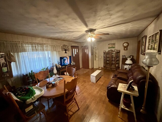 dining room with hardwood / wood-style flooring and ceiling fan