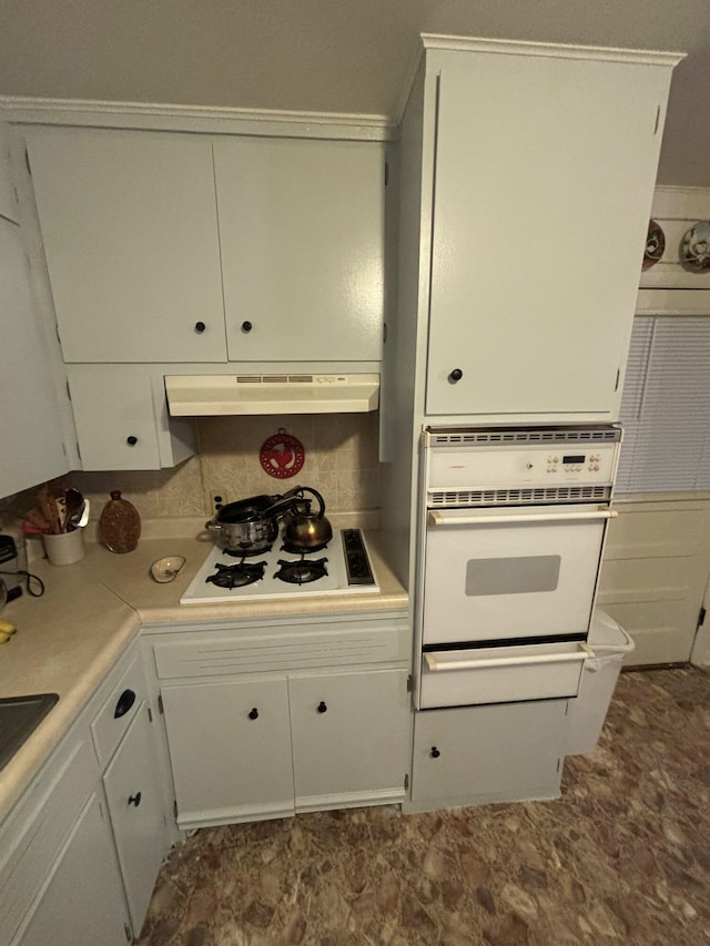 kitchen with white appliances and white cabinetry