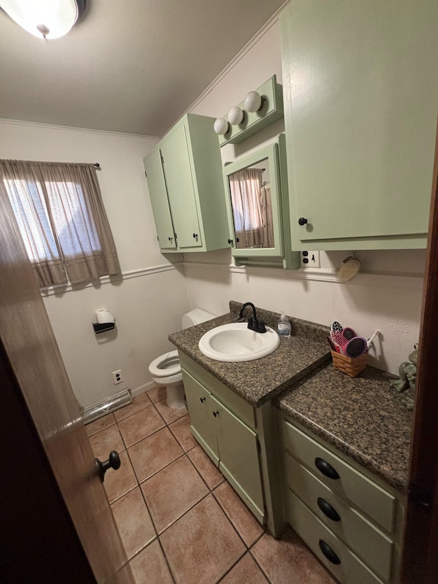 bathroom featuring vanity, tile patterned flooring, and toilet