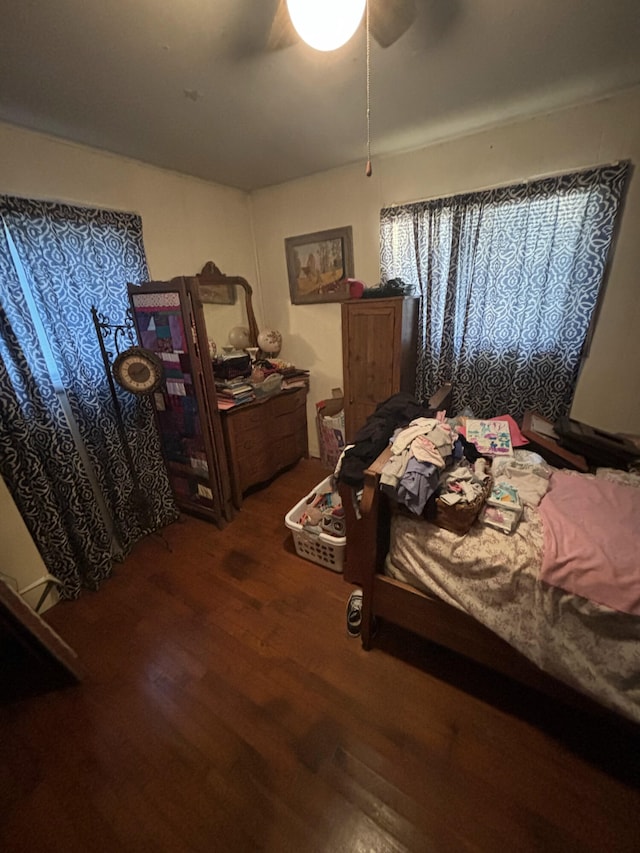 bedroom with ceiling fan and dark hardwood / wood-style floors