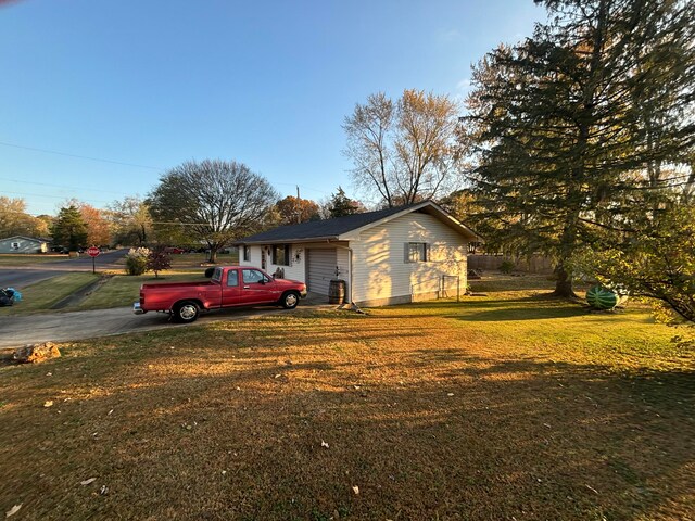 view of property exterior with a lawn