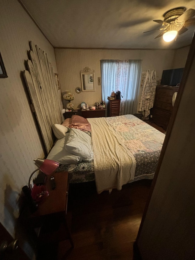 bedroom with hardwood / wood-style flooring and ceiling fan