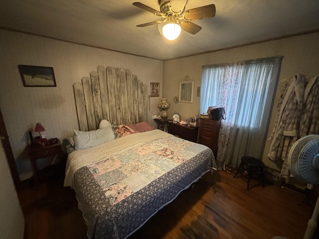 bedroom with dark hardwood / wood-style flooring and ceiling fan