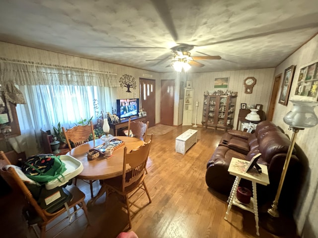 living room featuring hardwood / wood-style floors and ceiling fan