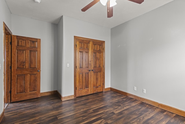 unfurnished bedroom with dark hardwood / wood-style flooring and ceiling fan