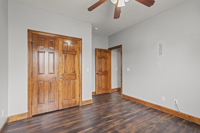 unfurnished bedroom with a closet, dark hardwood / wood-style floors, and ceiling fan