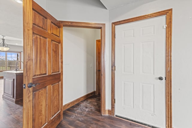 hallway featuring dark hardwood / wood-style floors and sink