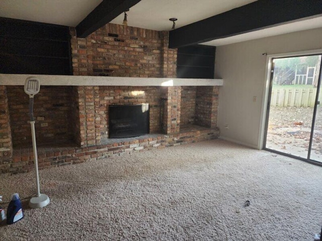 unfurnished living room featuring beam ceiling and carpet floors