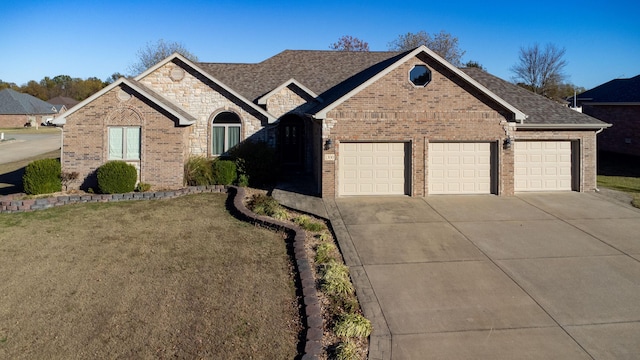 view of front of property with a garage and a front lawn